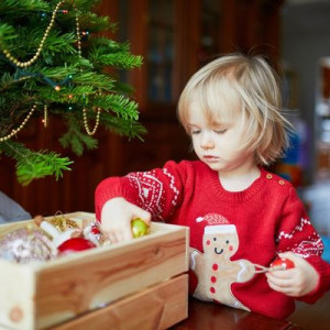boy playing with Christmas decorations