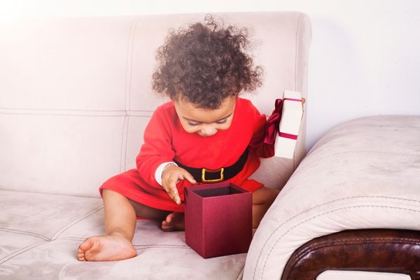toddler playing a christmas unwrapping activity