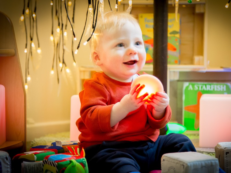 A baby boy in the baby nursery room at Angels At Play Nursery in Hoddesdon