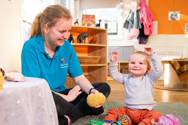 All About Children nursery practitioner looking after a toddler